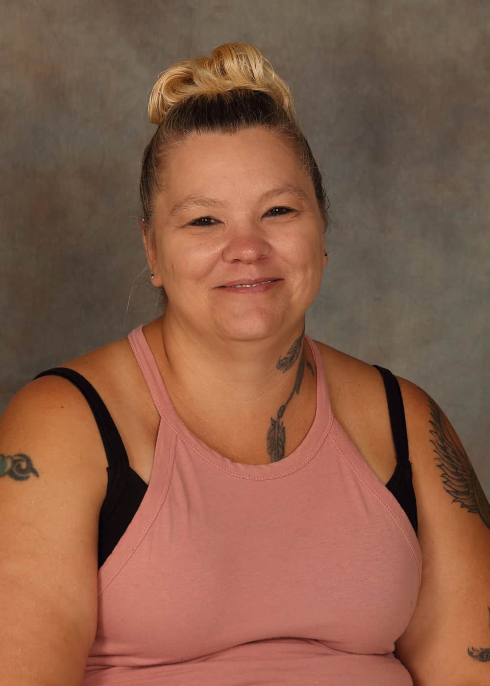 Photo of Lead Teacher Rhonda Coleman. She is a Caucasian woman with brown and blonde hair in a bun, and a pink shirt.